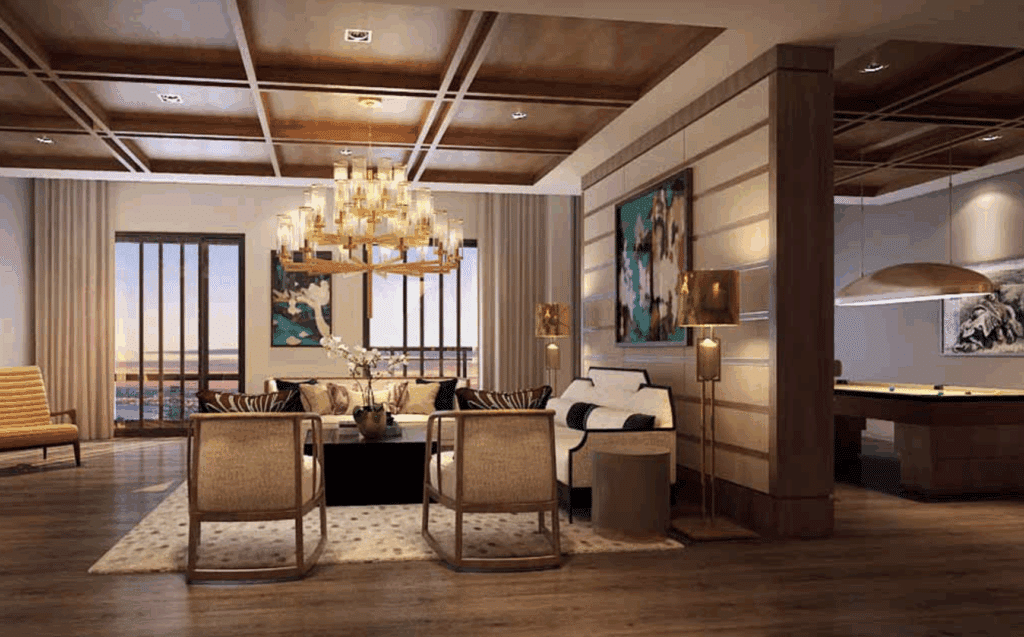 Luxury lounge area with classic wood detailing, chandelier, and plush seating.